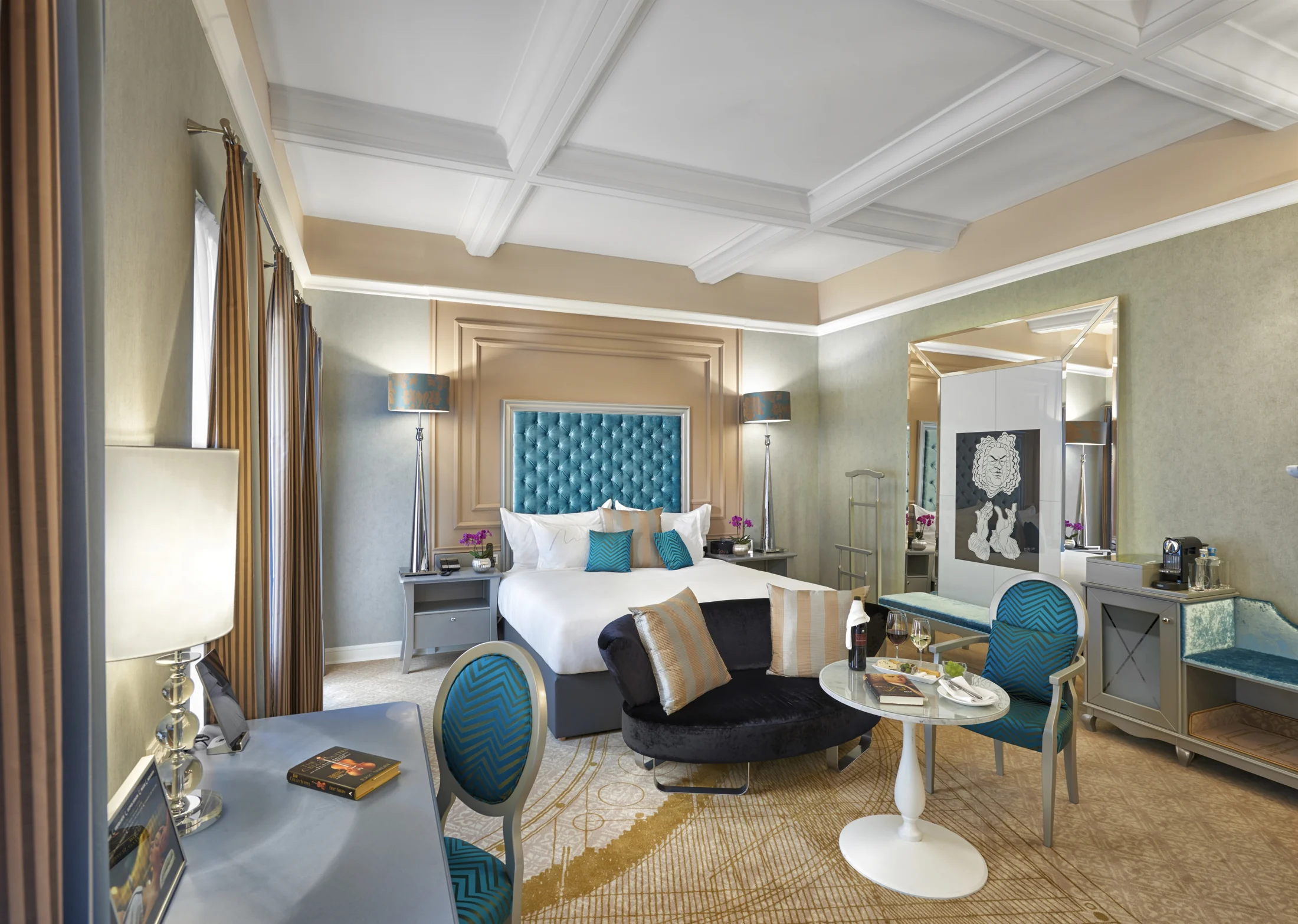 Elegant hotel suite with seating area and blue accents in Budapest