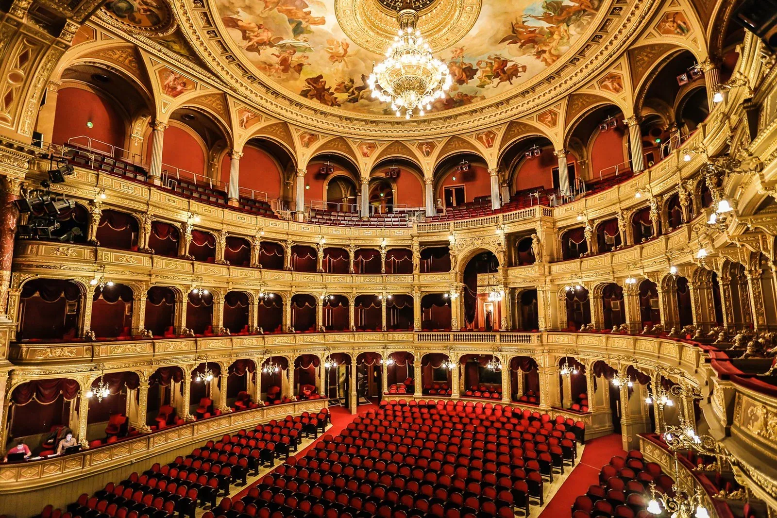 Ornate balconies and red seating inside the Hungarian State Opera House in Budapest