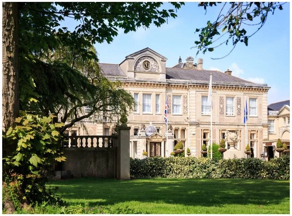 Down Hall country house framed by mature trees