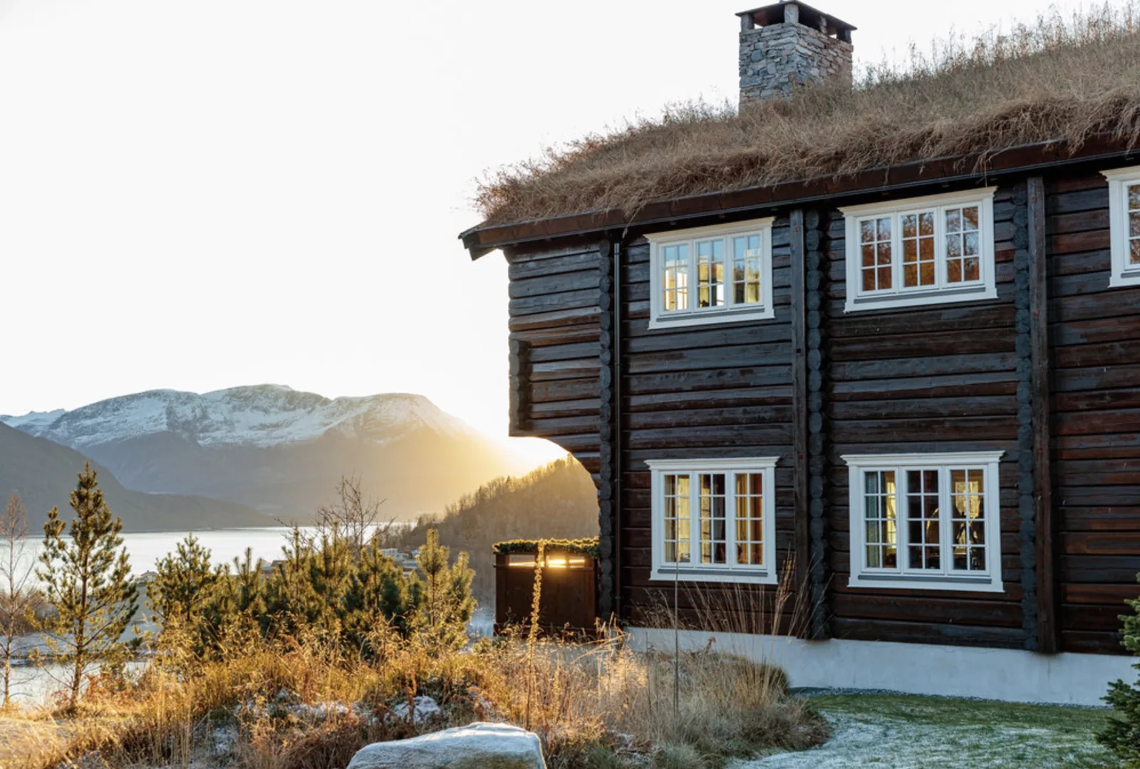 Traditional timber lodge overlooking a Norwegian fjord